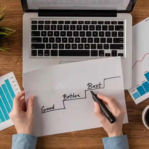 top-view-office-desk-with-growth-chart-held-by-hands_11zon_11zon